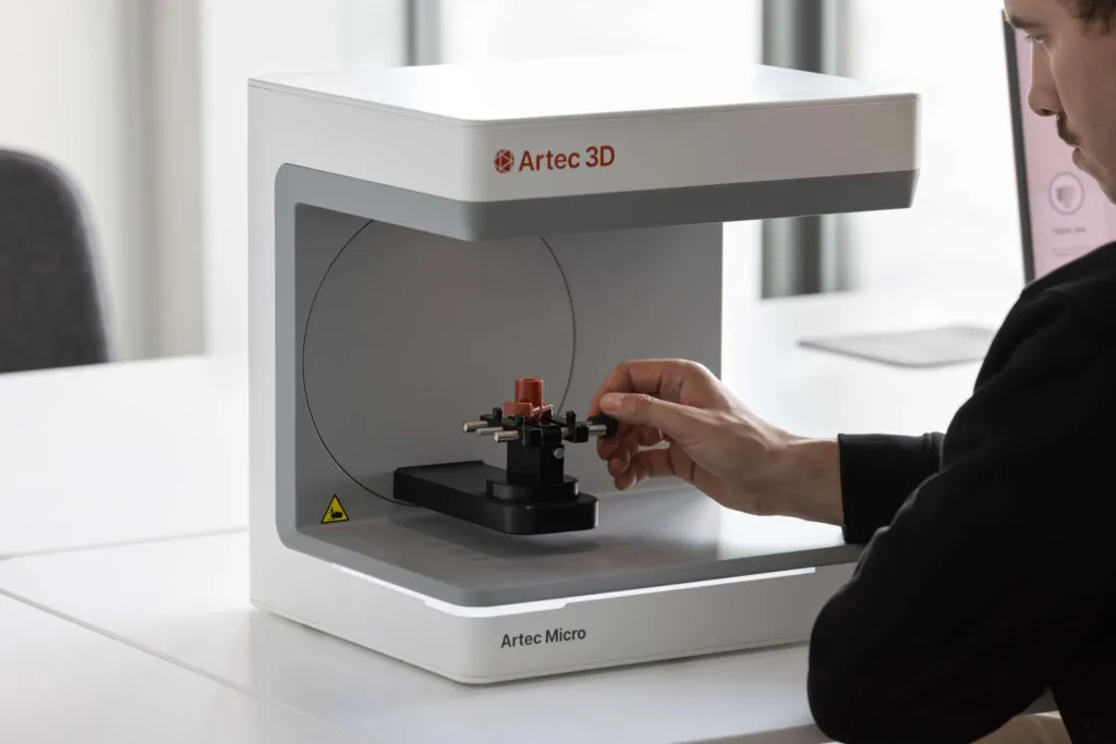 A person using the Artec Micro 2 Desktop Scanner to scan a small detailed part