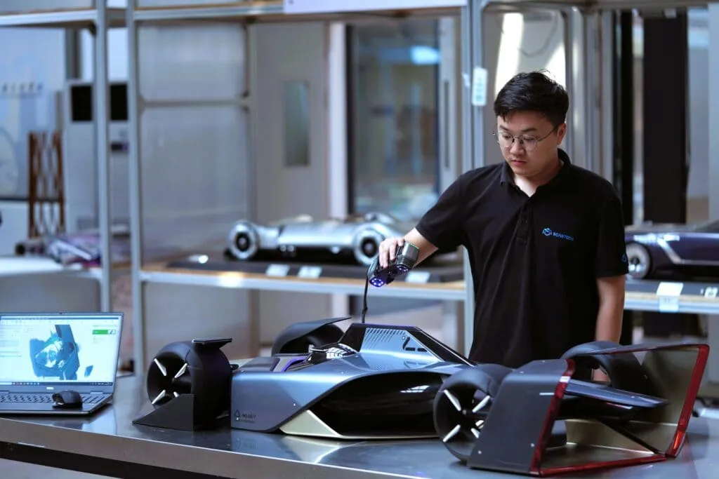 An engineer 3D scanning a large metal part