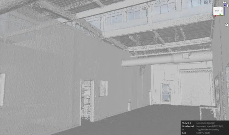 Grayscale point cloud of a warehouse interior showing a hallway and roof rafters