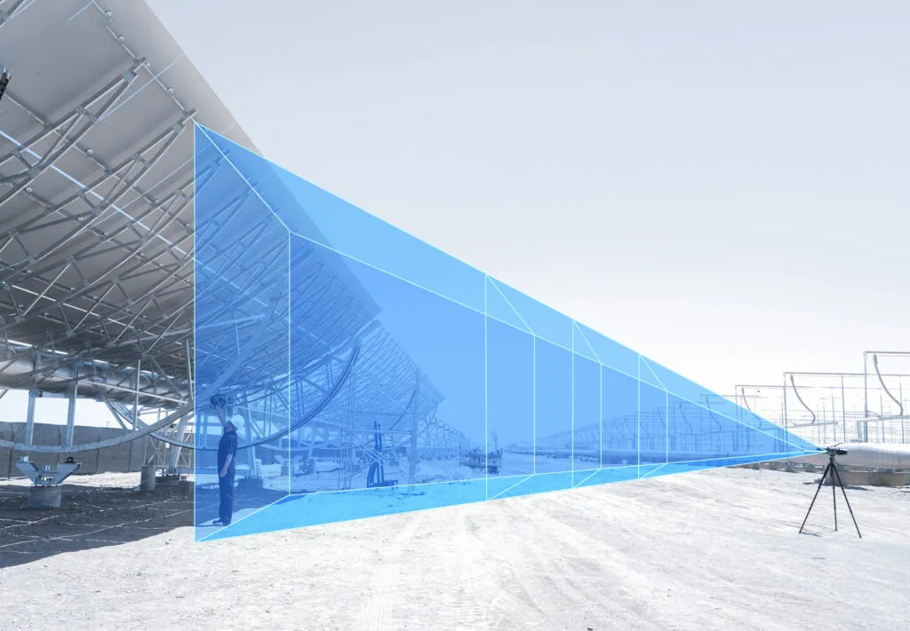 Blue measurement volume projected across a large parabolic solar collector, showing the TrackScan Sharp-Z tracking field at up to 12 m